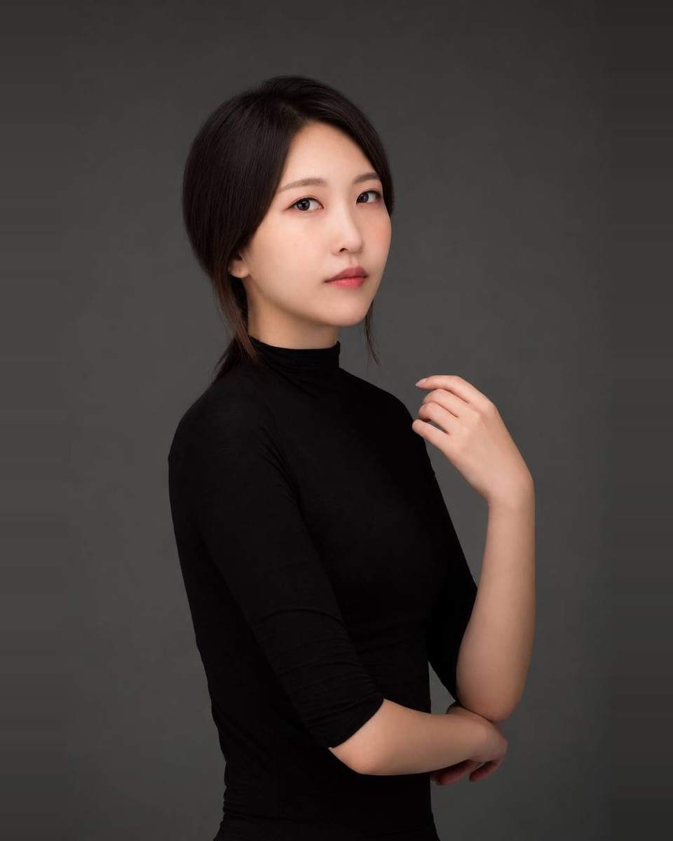 Dayeon Lee in a black high-neck top against a dark gray background